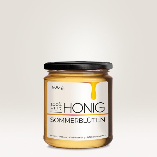 Ein Honigglas mit einem Etikett, auf dem "100 % HONIG Sommerblüten" steht.
