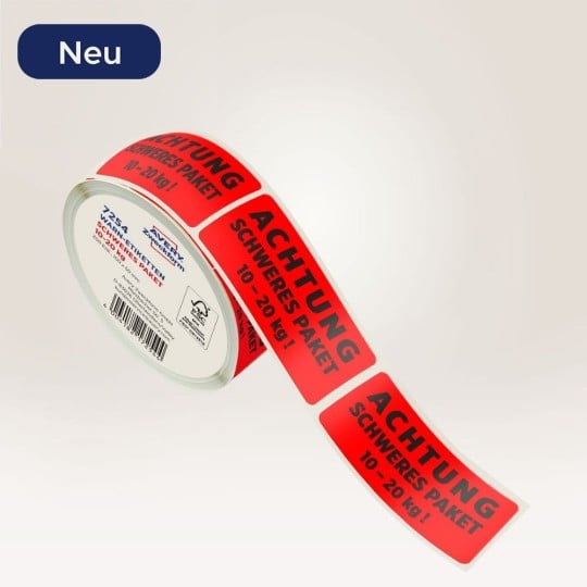 Rote Warnetiketten Schweres Paket. Rote Warnetiketten Achtung schweres Paket auf einer Rolle.