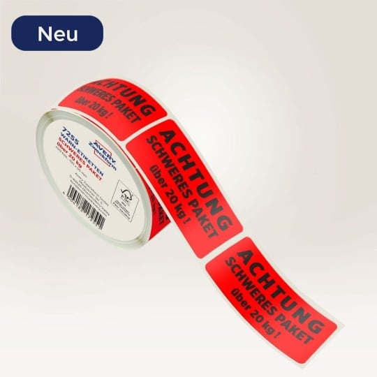 Rote Warnetiketten Achtung schweres Paket. Rote Warnetiketten Achtung schweres Paket sind auf einer Rolle.
