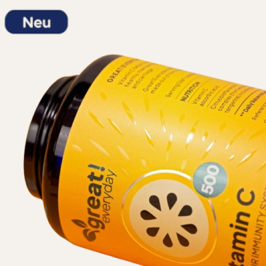 Man sieht ein liegendes Tablettenglas. Auf diesem ist ein gelbes Etikett geklebt, auf dem verschiedene Texte und Grafiken zu sehen sind. Das Etikett ist mit Spotlack und Goldfolie veredelt.