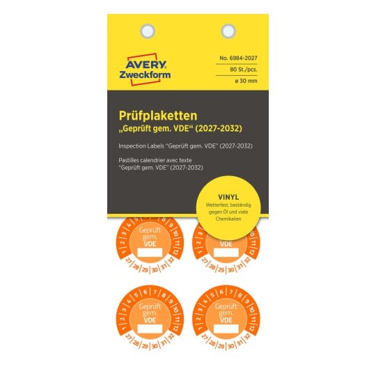 Dieses Bild zeigt Etiketten zur Inspektion, spezifiziert als 'Geprüft gem. VDE' mit einer Produktionsnummer sowie Informationen über Material und Haltbarkeit.