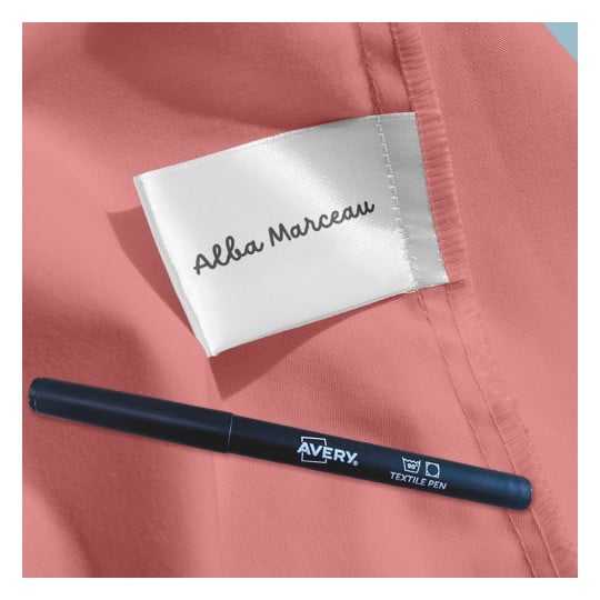 Das Bild zeigt einen rosa Stoff mit einem Kleidungsetikett der Marke 'Alba Marceau'. Daneben befindet sich ein Avery Textilstift.