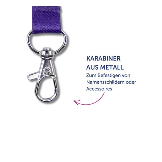 Das Bild zeigt einen Metallkarabiner, der an einem lila Band befestigt ist, mit einem Text in deutscher Sprache, der seine Verwendung zum Anbringen von Namensschildern oder Accessoires beschreibt.