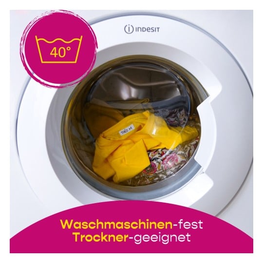Eine geöffnete Waschmaschinentür, die ein gelbes Hemd und einen bunten Stoff zeigt, mit einem 40°C-Waschbefehlssymbol.