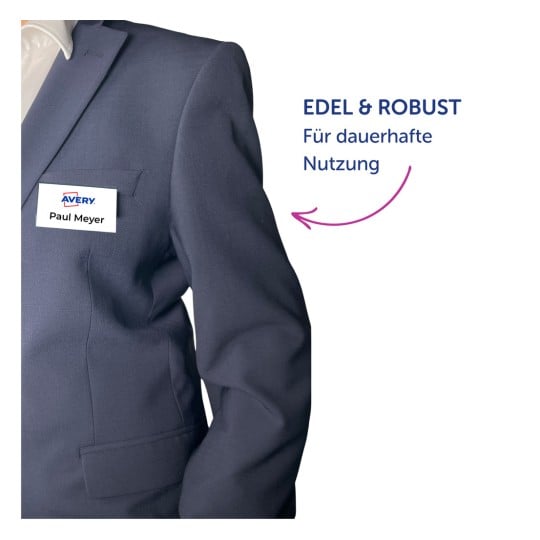 Oberkörper mit marineblauem Blazer, mit einem weißen Namensschild mit der Aufschrift „Paul Meyer“?