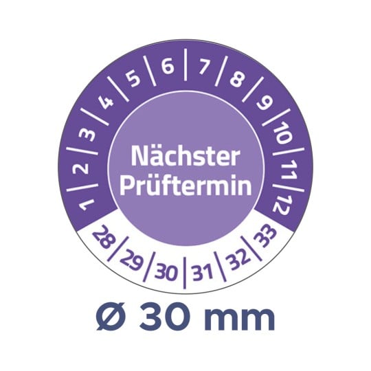 Das Bild zeigt ein rundes lila Etikett, das Informationen über das nächste Prüfdatum bietet. Es sind Zahlen von 1 bis 12 und 28 bis 33 am Rand angeordnet. Es steht 'Nächster Prüftermin' und weist einen Durchmesser von 30 mm auf.
