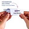 Hände, die eine bedruckte Avery-Namensschildkarte in einen durchsichtigen Kunststoffhalter einsetzen?