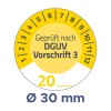 Das Bild zeigt ein rundes Messgerät mit Markierungen, die eine Messung von 20 anzeigen, und den Text 'Geprüft nach DGUV Vorschrift 3' zusammen mit einem Durchmesser von 30 mm.