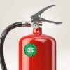Das Bild zeigt eine Nahaufnahme eines roten Feuerlöschers. Der Feuerlöscher ist mit einem Griff und einer Düse ausgestattet, sowie einem Druckmesser oben, der den Status anzeigt. Auf dem Körper befindet sich ein grünes rundes Etikett mit der Nummer 26.