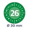 Das Bild zeigt ein grünes kreisförmiges Gerät mit der Zahl 26, die prominent in der Mitte angezeigt wird, umgeben von den Zahlen 1 bis 12 und zusätzlichen Markierungen. Unten wird 'Ø 30 mm' erwähnt, was einen Durchmesser anzeigt.