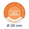 Das Bild zeigt ein Kreisdiagramm mit Zahlen am Rand, das einen gemessenen Durchmesser von 30 mm angibt. In der Mitte steht der Text 'Geprüft nach DGUV Vorschrift 3', was auf die Einhaltung einer deutschen Sicherheitsvorschrift hinweist.