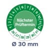 Das Bild zeigt einen runden Kalender, der das nächste Prüfdatum mit der Aufschrift 'Nächster Prüftermin' angibt, umgeben von Zahlen, die Daten darstellen, mit einem Durchmesser von 30 mm angegeben.