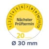 Das Bild enthält eine Anzeige oder ein Zifferblatt mit Zahlen von 1 bis 12, in der Mitte beschriftet mit 'Nächster Prüftermin' und am unteren Rand die Angabe 'Ø 30 mm'.